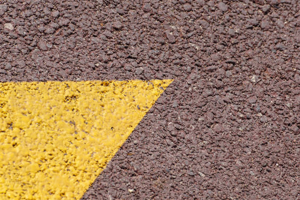 istock Asphalt background texture with some fine grain with Yellow Stripe 901618660