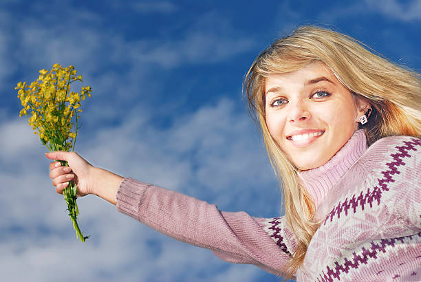 istock The smiling girl with flowers 90162063