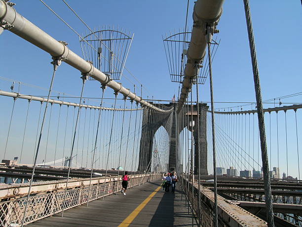 istock Pedestrians and Joggers on Bridge with Cables 90162263