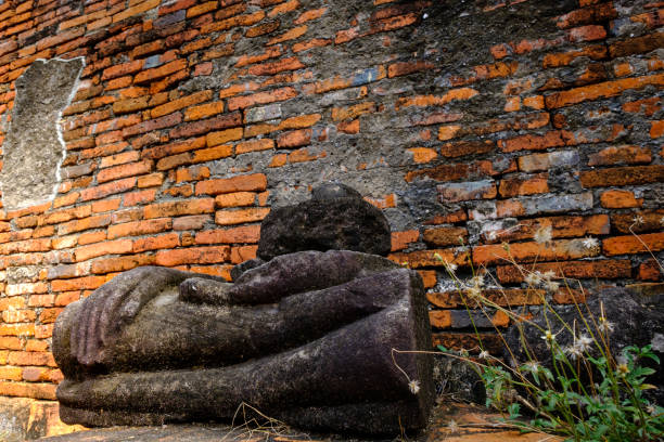 Ancient Buddha ruins and old brick wall on ancient monuments that are over 200 years old. Wat Nakhon Luang Tample,Prasat Nakhon Luang public domain or treasure of Buddhism in Nakornluang, Ayutthaya, Thailand