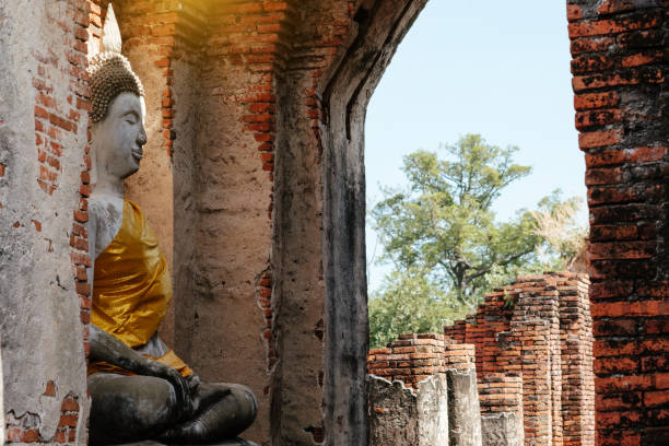 istock Ancient Buddha and old brick wall on ancient monuments that are over 200 years old. Wat Nakhon Luang Tample,Prasat Nakhon Luang public domain or treasure of Buddhism in  Ayutthaya, Thailand 901626354