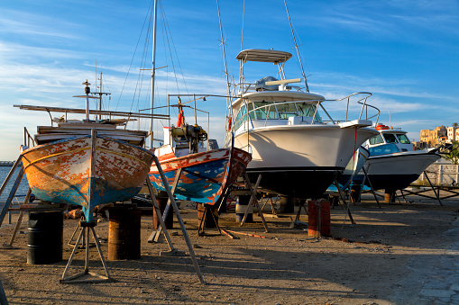 Colorful fishing boats in Inner Harbor and Prospect Harbor Point lighthouse, Maine Atlantic shore, USA
