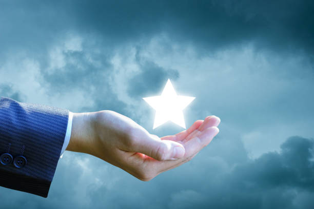 istock Hand shows a star in the sky. 901633838
