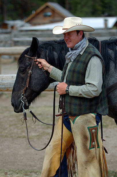 istock Cowboy Holding Blue Roan Horse 90163504