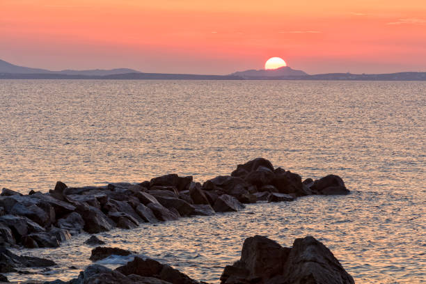 Sunset over Paros island viewed from Naxos island in the Aegean Sea, Cyclades, Greece, HDR image