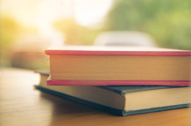 istock Vintage old books on wooden deck tabletop 901642178