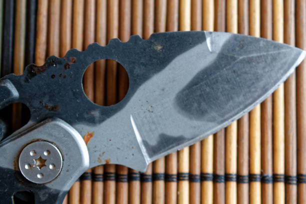 istock Small jackknife on a wooden background, top view. 901643034