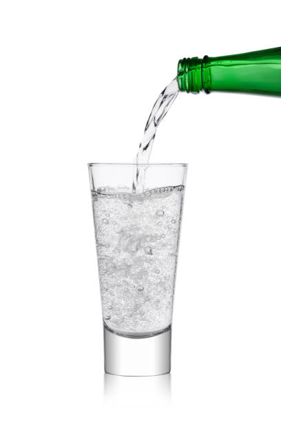 istock Pouring lemonade soda drink from bottle to glass 901643946