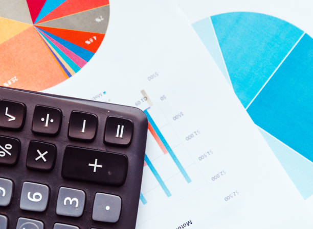 istock Preparing report. Blue graphs and charts. Business reports and pile of documents on gray reflection background. 901644212