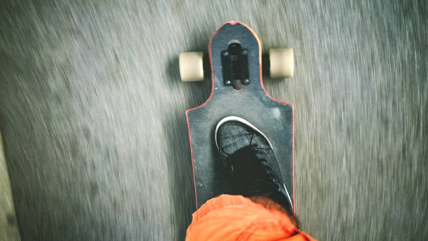 istock Longboarder driving on the street 901646986