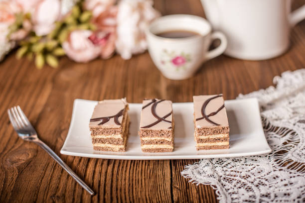 slice of layered cake with tea or coffee
