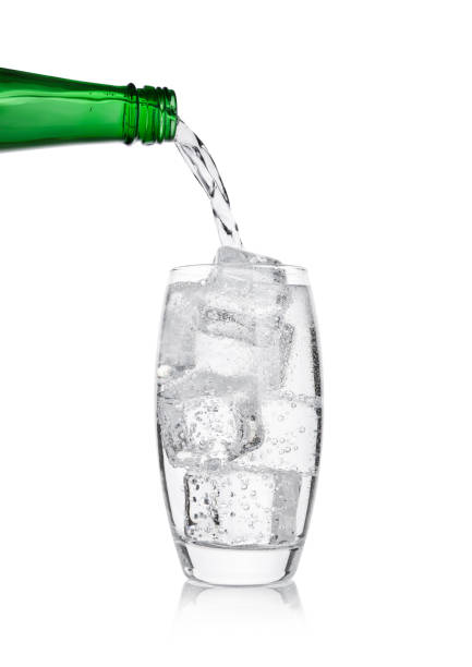 istock Pouring lemonade soda drink from bottle to glass 901657482