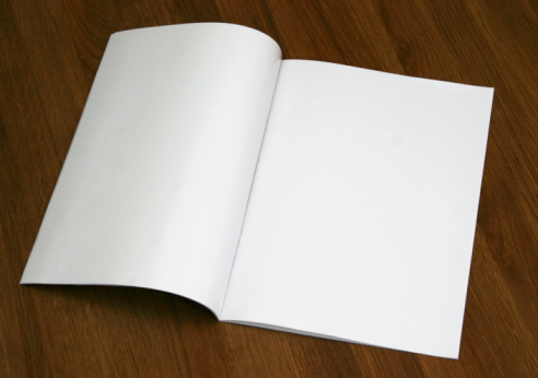 Blank magazine spread on a wooden table (Insert your own design or content). Could also be used as a test, contract and etc.
