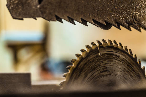 istock Blurred background with disc electric circular saw close-up. Carpentry sawing machine. Mechanized woodworking carpenter tool. 901665894