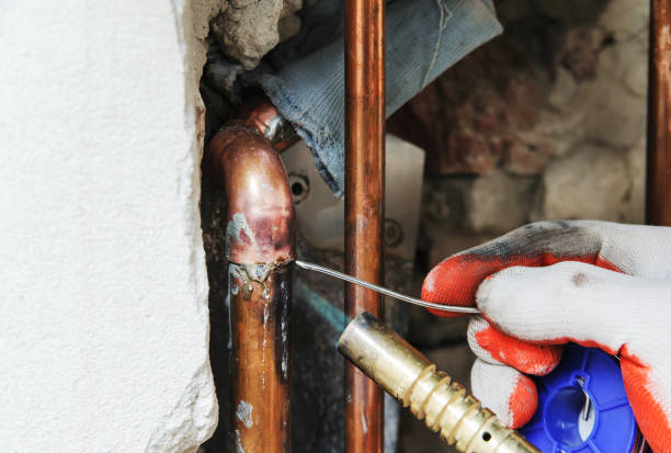 istock A worker is  soldering copper pipes. 901666278