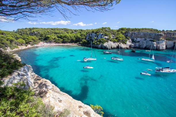 Boats and yachts on Macarella beach, Menorca, Spain Panorama view of Macarella beach in Menorca, Balearic Islands, Spain minorca photos stock pictures, royalty-free photos & images