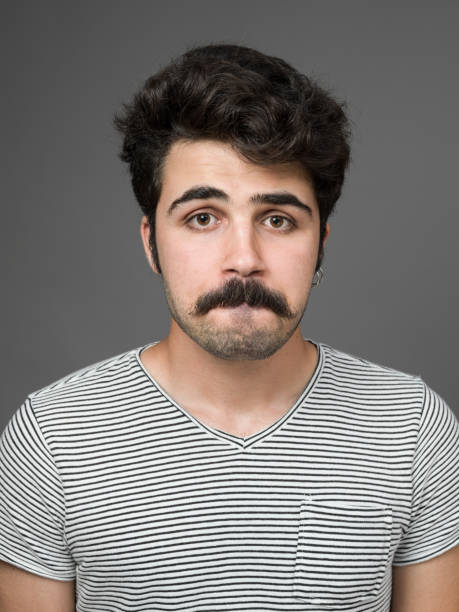 istock Mugshot Of Young Man Making A Face 901669598