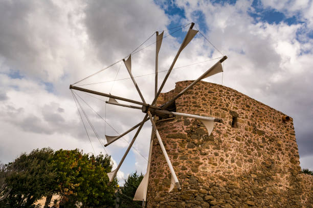 Old stone windmill near Toplou monastery in Crete, Greece. Toplou monastery is located on the eastern part of the island of Crete in Greece.