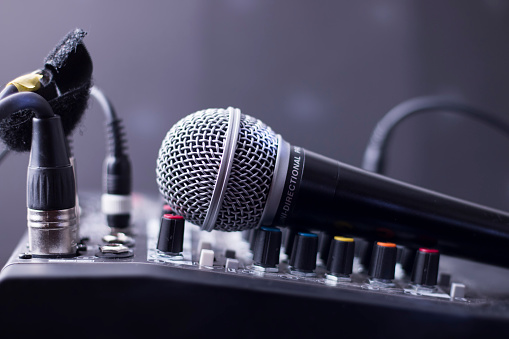 Closeup of microphone on mixing table audio equipment.