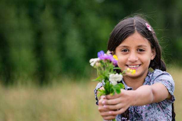 istock Beautiful girl with picked flowers 901674130