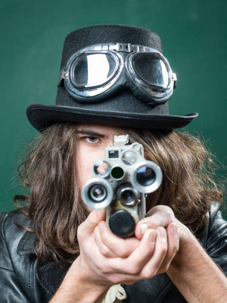 istock Young Man In Old Fashioned Style Filming Via Antique Camera 901675218