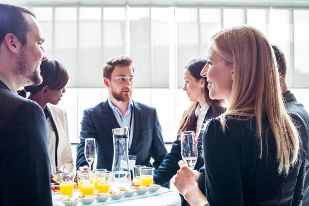 Business party Business people standing around the table with canapes and drinks while talking canape stock pictures, royalty-free photos & images