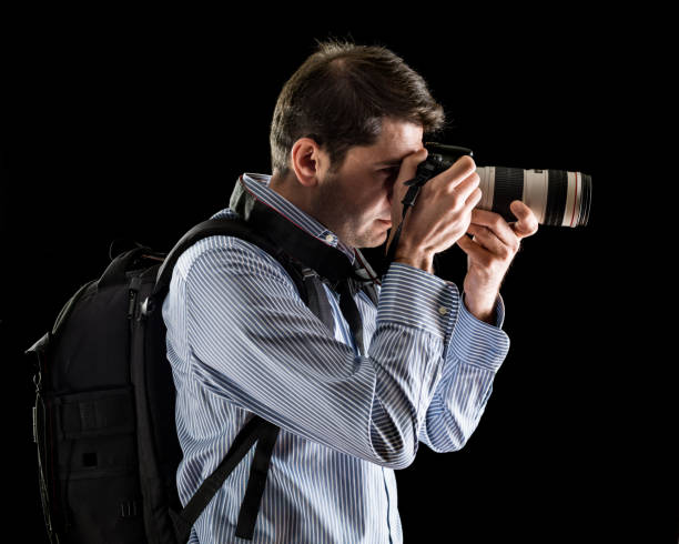 istock Photographer Photographing On Black Background 901677776