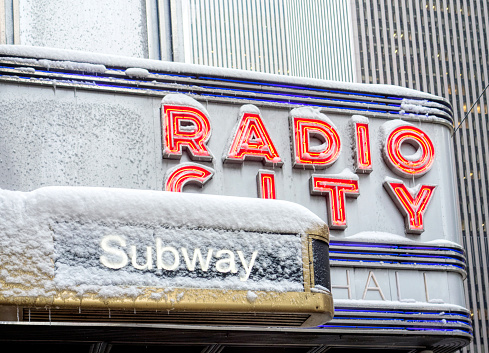 New York City, NY, USA - February 08, 2017: Close up shot of Radio City sign covered with snow and ice, in New York City