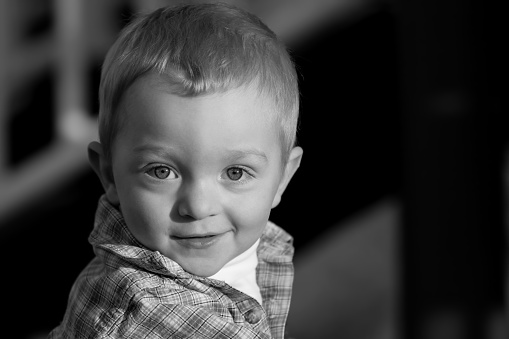 portrait of a young, redheaded boy in the late afternoon sun - converted to black and white
