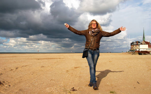 Woman on the Normandy Beach holding shells
