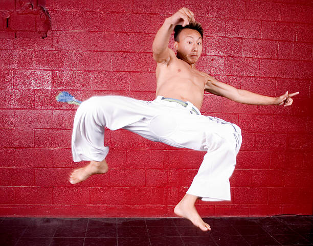 karate kick - men jumping mid air air pump zdjęcia i obrazy z banku zdjęć