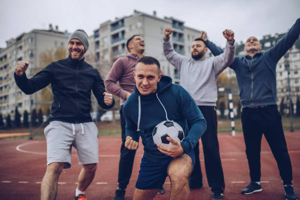 istock Friends celebrating victory on a soccer playing field 901689122