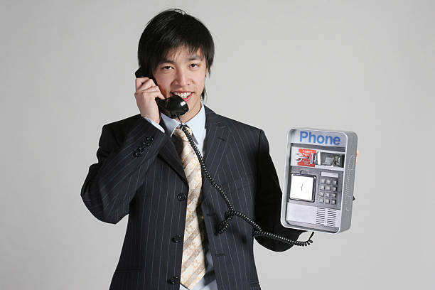 Angry Adult Asian man  shout with tin can phone on white background