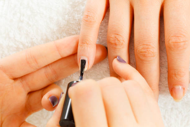 istock Woman in beauty salon getting manicure done. 901689206