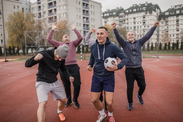 istock Friends celebrating victory on a soccer field 901689594