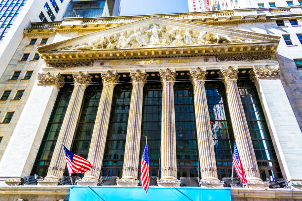 Image of the famous American stock exchange located at the 11 Wall Street, Lower Manhattan, New York City. New York Stock Exchange building building is designated National Historic Landmarks in 1978.  The New York stock exchange opens nearly all year around except public holidays and weekends, the exchange opens from 9:30am till 4pm Eastern Time. The New York Stock Exchange provides platform for traders (buyers & sellers) to trade shares of registered companies.