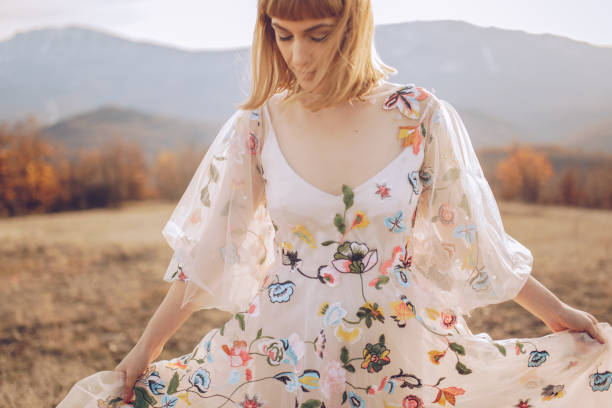 istock Beautiful hippie woman dancing in a meadow 901701266