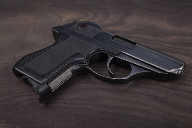 istock handgun on the wooden table 901708900