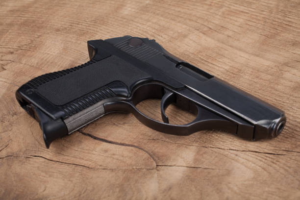 istock handgun with ammunition on the wooden table 901709006