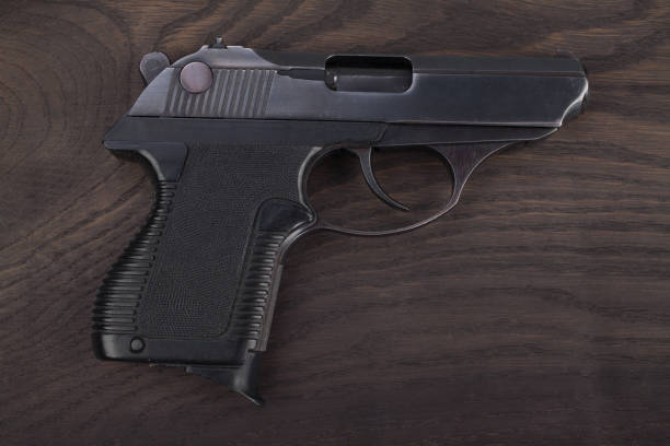 istock handgun on the wooden table 901709098
