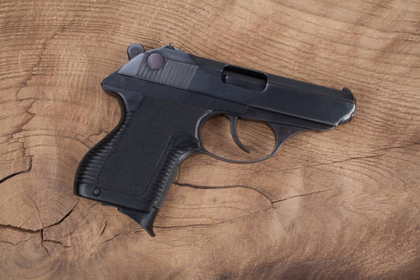 istock handgun with ammunition on the wooden table 901709138