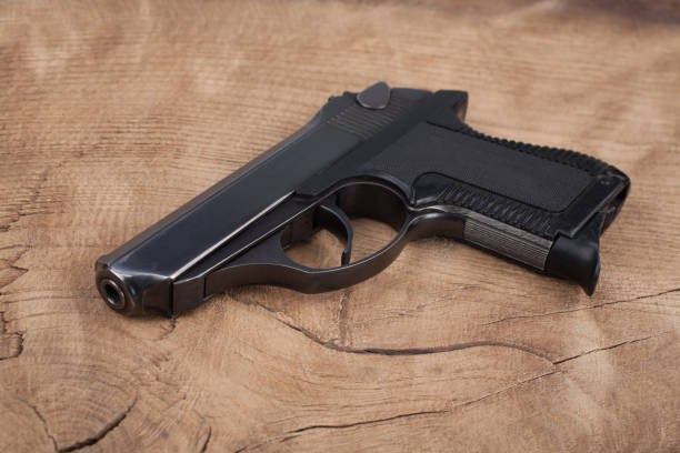 istock handgun with ammunition on the wooden table 901709196