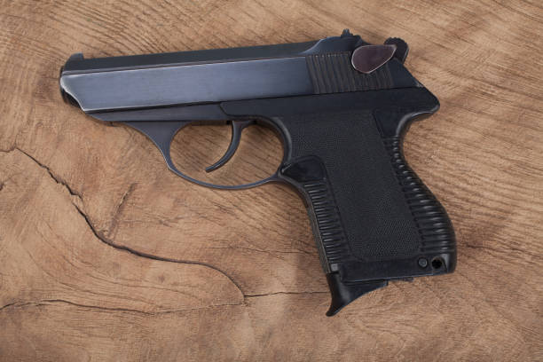 istock handgun with ammunition on the wooden table 901709232