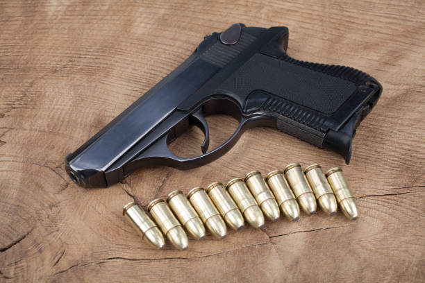 istock handgun with ammunition on the wooden table 901709364