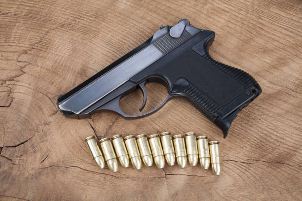 istock handgun with ammunition on the wooden table 901709406