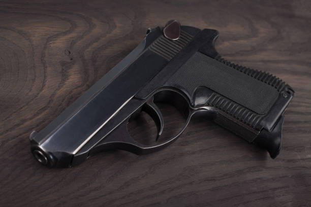 istock handgun on the wooden table 901709480