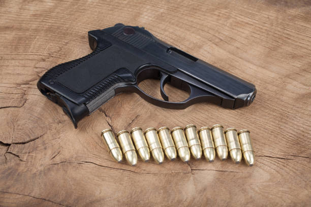istock handgun with ammunition on the wooden table 901709636