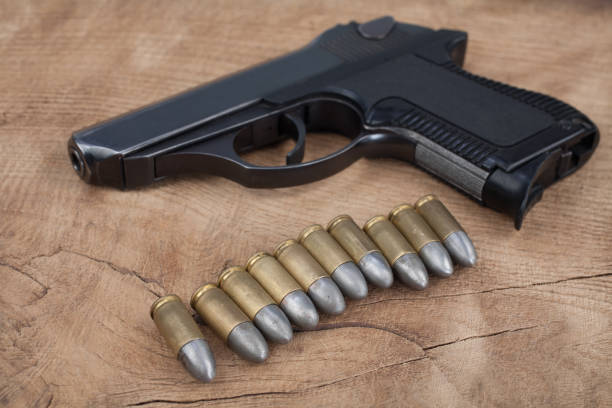 istock handgun with ammunition on the wooden table 901709760