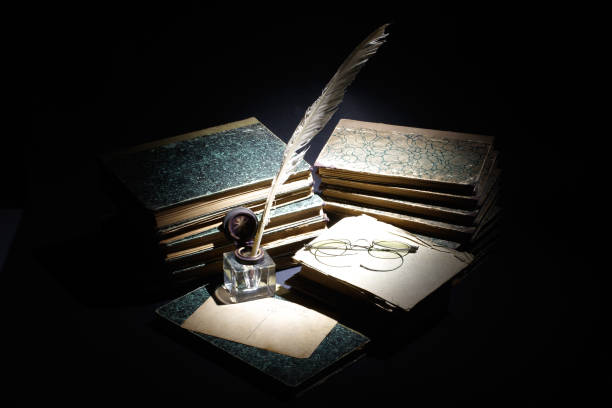 istock old books, papers, ink pen and inkpot on black background 901709994