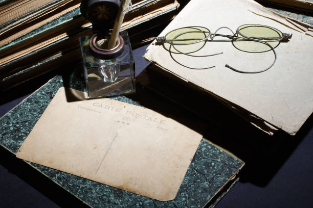 istock old books, papers, ink pen and inkpot on black background 901710138